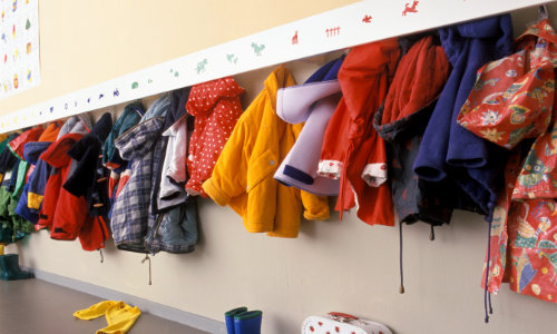 Coats hung up on coat hooks in school