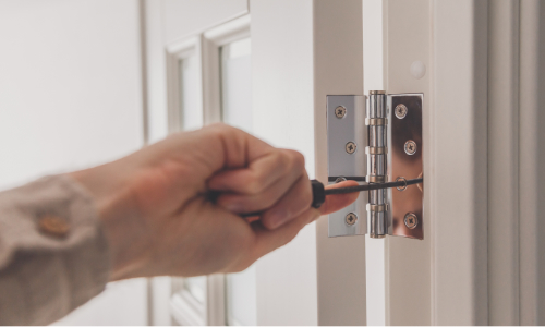 Hinge being fitted to a door