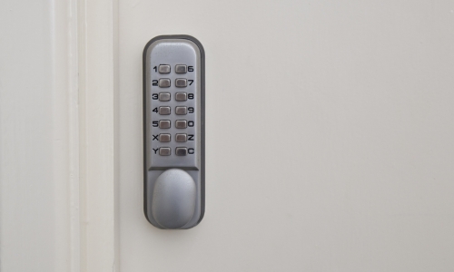 Knob-operated digital door lock on a timber door.