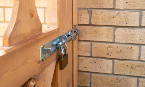 Bolt and padlock on gate