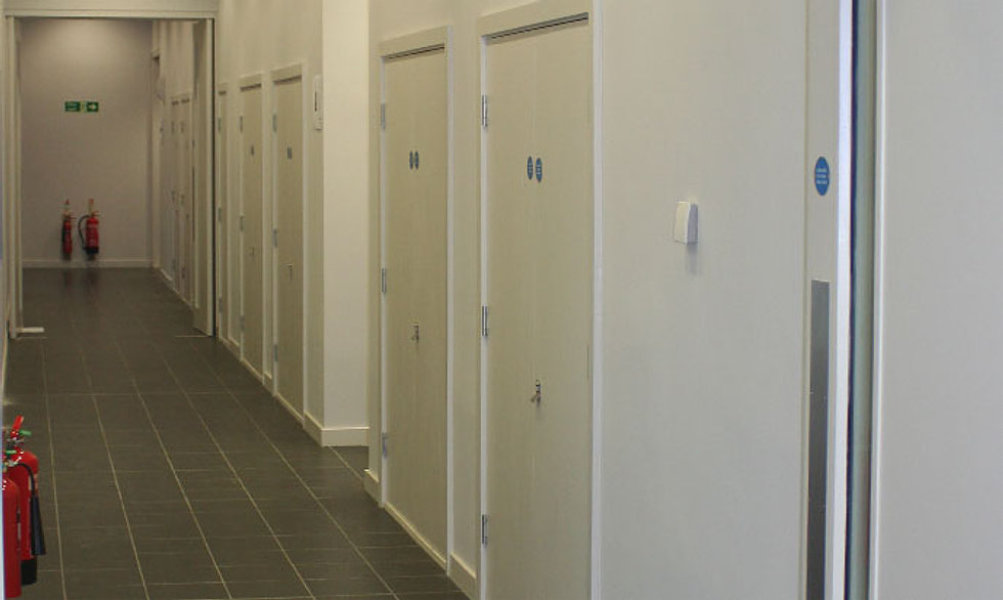 Corridor with multiple white FDKL doors