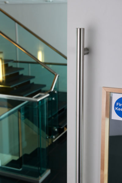 Stainless steel T bar handle on a fire door