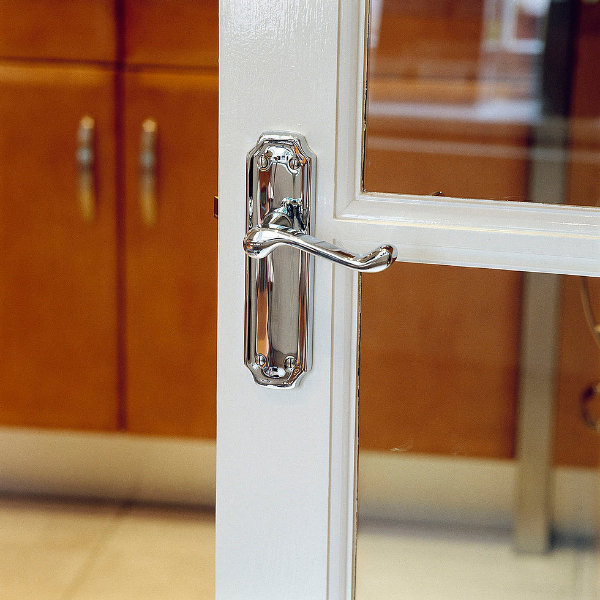 Silver lever latch door handle on glazed door