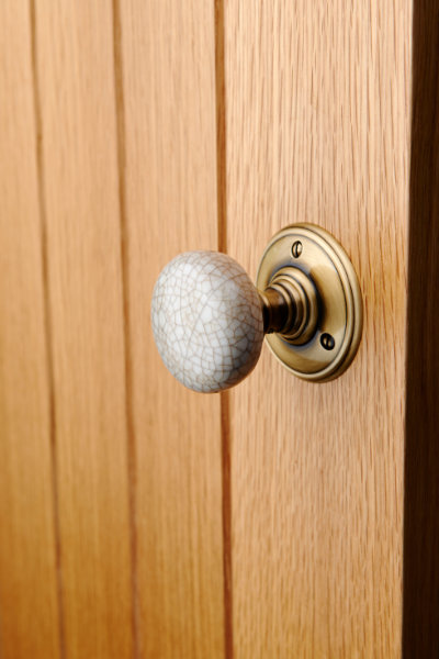 Porcelain door knob on antiqur brass rose on door