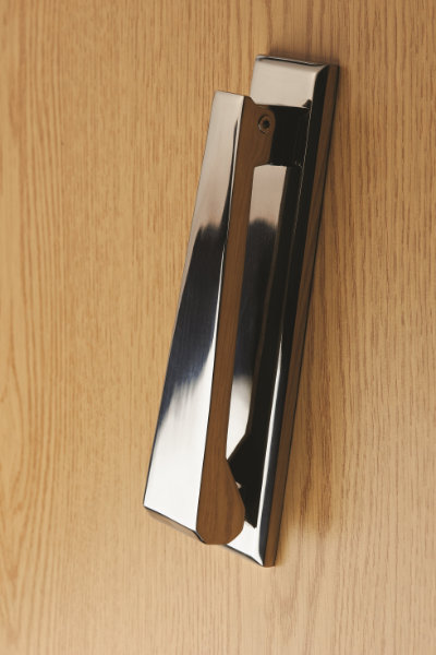 Modern silver door knocker on door